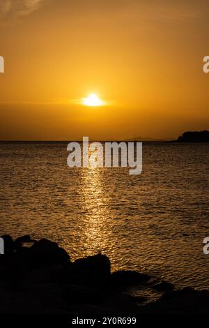 Beautiful sunset over small tourist town of Primosten, Croatia Stock Photo