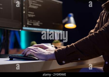 Computer scientist typing on keyboard, implementing security measures to protect company systems and data. IT specialist writing, testing and debugging Java code for software applications, close up Stock Photo