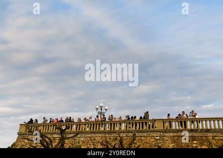 Tourists enjoying the view of Florence from the terrace of Piazzale Michelangelo on the Easter Sunday at sunset, Florence, Tuscany, Italy Stock Photo