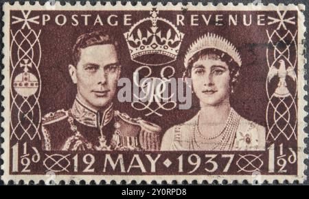 King George VI of Great Britain with wife Elizabeth at the coronation in 1937. Portrait on English postage stamp Stock Photo