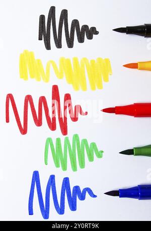 Watercolor pens brush, assortment, on a drawing album, artist's desk, top view, close-up, selective focus Stock Photo