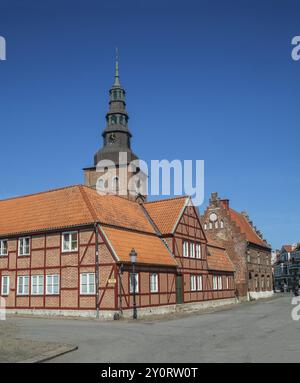 Old half-timbered building from the 18th century with St. Mary's Church from the 13th century in the background in the old center of Ystad, Skane Coun Stock Photo