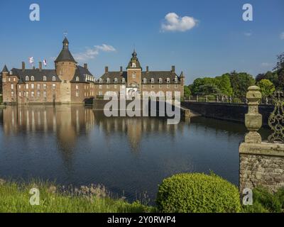 Historic castle with towers and green areas reflected in the water under a blue sky, Anholt, North Rhine-Westphalia, Germany, Europe Stock Photo