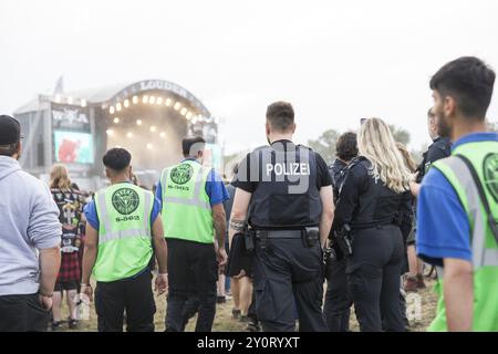 Police officers and metal guards in front of the Louder stage at the Wacken Open Air in Wacken. The traditional metal festival will take place from 31 Stock Photo