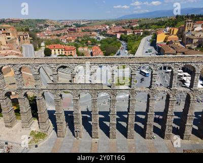 Aerial view of a historic city area with an aqueduct and various buildings as well as a busy street, Aerial view, Aqueduct, Segovia, Castilla y Leon, Stock Photo