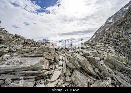 Mountaineer in a rocky saddle, Lapenscharte with view of mountain peaks, Berliner Hoehenweg, Zillertal Alps, Tyrol, Austria, Europe Stock Photo