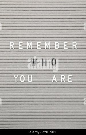 Letter board with phrase Remember who you are as background, top view Stock Photo