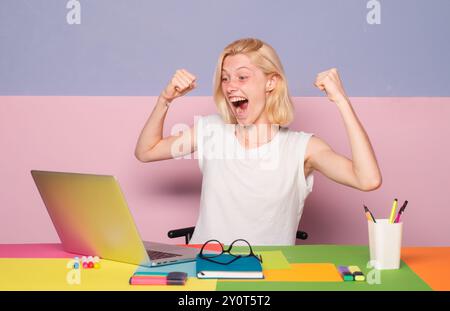 Excited amazed teacher works on laptop. Shcool teacher in class. Professional emotional portrait. Stock Photo