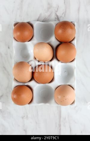 Top View Eggs on Ceramic Egg Tray, Isolated on White Marble Table Stock Photo
