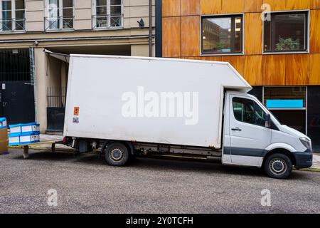 White delivery truck parked in front of building in a city Stock Photo