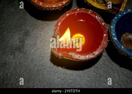 A row of small red and blue candles are lit, creating a warm and inviting atmosphere. The candles are arranged in a circle, with one of them having a Stock Photo
