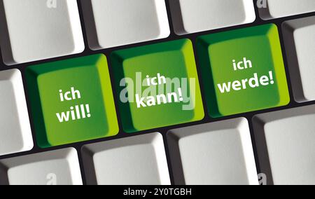 A closeup photo of a keyboard featuring motivational German phrases I want, I can, I will on its keys Stock Photo