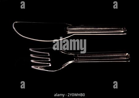 plastic fork and knife on black background Stock Photo