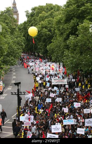 An estimated 100,000 Tamils marched through London today from Hyde Park  to Temple Place, calling for justice in Sri Lanka and a separate Tamil  state there. The march was led by a group of 'detainees' in a barbed  wire prison camp to dramatise the terrible conditions of civilians held  in internment camps and demanded their immediate release as well as full  UN access to the camps. Some also carried photographs of their relatives who have been killed or  who have disappeared and demanded that the Sri Lankan government and  army be tried for war crimes, as well as calling for economic sanction Stock Photo