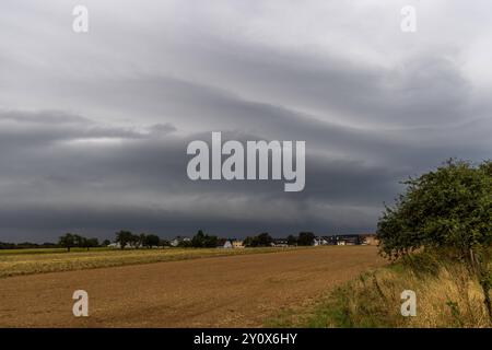 Gewitter im September Dunkle Wolken einer aufziehenden Gewitterfront sind am Morgen über den Feldern zu sehen., Kronberg Hessen Deutschland *** Thunderstorm in September Dark clouds of an approaching thunderstorm front can be seen over the fields in the morning , Kronberg Hessen Germany Stock Photo