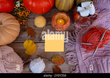 autumn Leaves, pumpkin, orange pyracantha Berries, paper blank, mockup on old wooden table, Halloween preparation, Jack-o'-lantern candlelight, Autumn Stock Photo