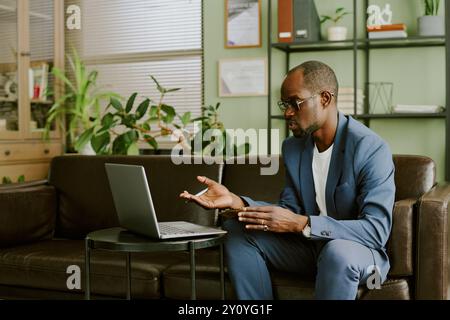 Businessman Conducting Virtual Meeting in Modern Office Stock Photo