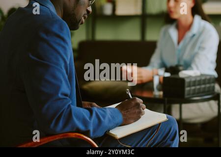 Businessman Taking Notes in a Meeting Room Stock Photo