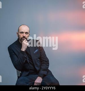 Man sitting in chair with light flare effect Stock Photo