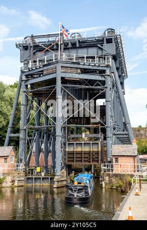 Canal narrowboat entering the Anderton boat lift, connecting the Trent and Mersey canal with the river Weaver at Anderton near Northwich Cheshire Stock Photo