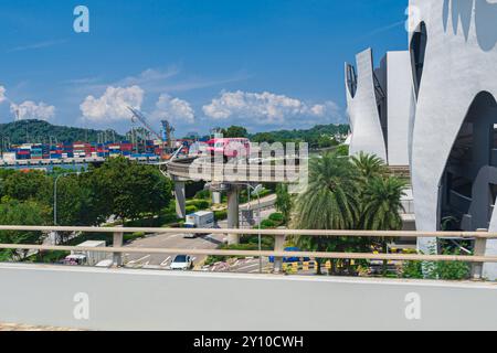 Singapore - Jun 13 2024: The Singapore Mass Rapid Train MRT runs on a track that leaves from Sentosa next to Vivo. The MRT is the second oldest, busie Stock Photo