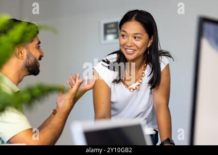Collaborating in modern office, colleagues discussing project details Stock Photo