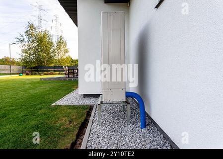 Two efficient outdoor heat pump units placed in front of the house. Stock Photo