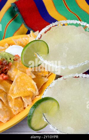 Cinco de Mayo Concept: Margaritas and Mexican food on a colorful  table cloth. Stock Photo