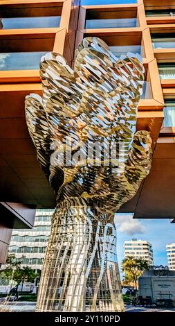 Prague, Czech Republic, October 8, 2023: Modern sculptural hand-shaped installation in front of contemporary building with geometric facade design Stock Photo