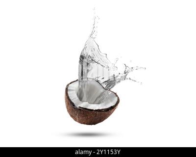 Fresh coconut water splashing from nut in air on white background Stock Photo