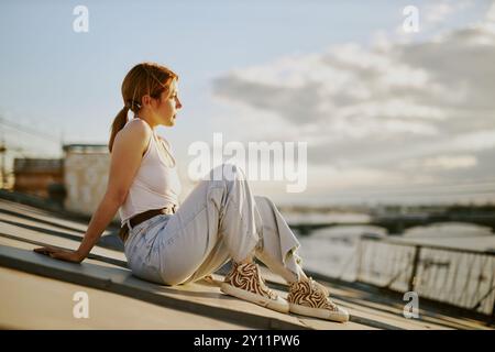 Relaxing on Rooftop Overlooking Cityscape at Sunset Stock Photo