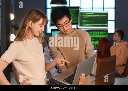 Young programmers working with laptop in office Stock Photo