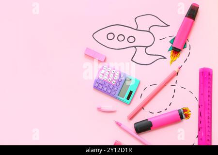 Creative composition with drawn rocket and different stationery on pink background Stock Photo