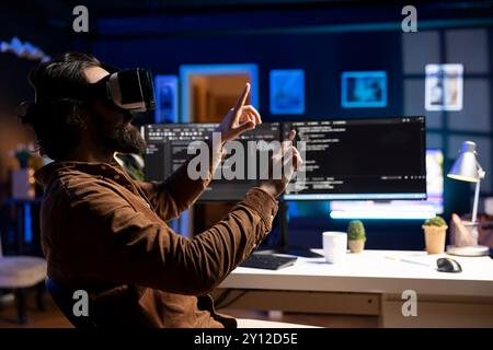 Man doing software quality assurance, reading source code using high tech VR headset. Developer inspecting coding using virtual reality technology, looking to fix potential issues Stock Photo