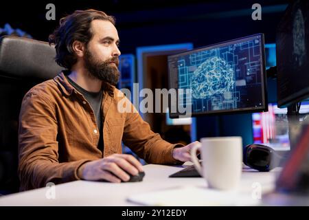 Software developer using computer for artificial intelligence computing simulating human brain through self learning algorithms. IT specialist working with AI deep neural networks on desktop PC Stock Photo