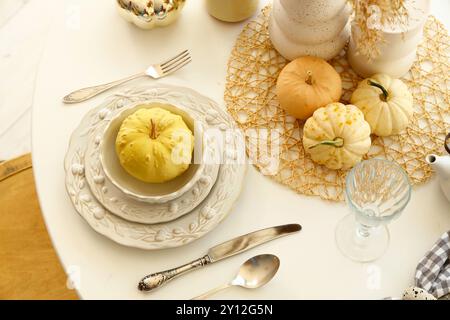 Elegant autumn table setting with pumpkins and crockery Stock Photo