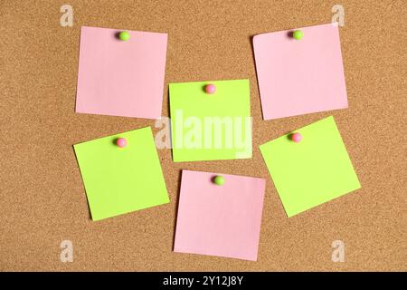 Different blank sticky notes on cork board as background Stock Photo