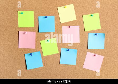 Different blank sticky notes on cork board as background Stock Photo