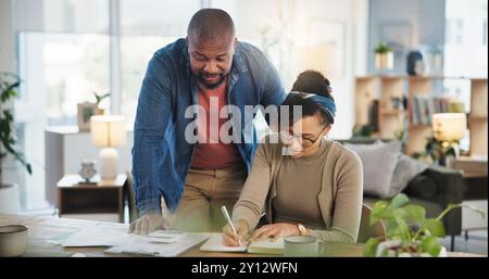 Financial paperwork, writing or African couple with planning or household budget in home. Bills, calculate or people filling form documents for Stock Photo