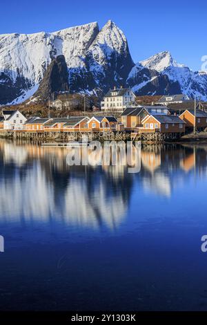 Wooden houses on a fjord off Bergen, morning light, reflection, winter, Reine, Moskenesoya, Lofoten, Norway, Europe Stock Photo