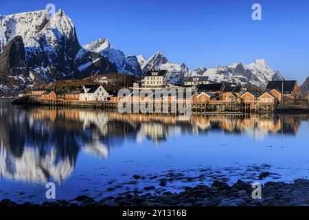 Wooden houses on a fjord off Bergen, morning light, reflection, winter, Reine, Moskenesoya, Lofoten, Norway, Europe Stock Photo