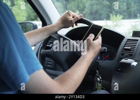 Photo of a man using smartphone while driving the car, transportation and vehicle concept with icon social media send email wifi chat read email Stock Photo