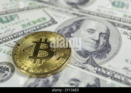 Gold Bitcoin macro photo on hundred dollars bills Stock Photo