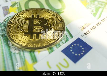 Macro photo of crypto currency concept, A bitcoin with euro bills Stock Photo