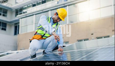 Engineer, man and screwdriver for solar panels, energy saving and electricity or heating of eco friendly grid on rooftop. Installation, digital Stock Photo