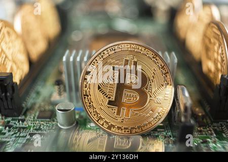 Bitcoin close-up on a computer circuit motherboard as a blockchain technology payment network. Digital cryptocurrency concept and mining Stock Photo