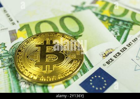 Macro photo of crypto currency concept, A bitcoin with euro bills Stock Photo