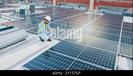 Inspection, man and tablet for solar panels, energy saving and electricity or heating of eco friendly grid on rooftop. Engineering, digital technology Stock Photo