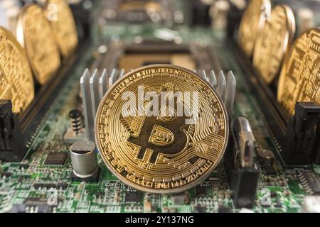 Bitcoin close-up on a computer circuit motherboard as a blockchain technology payment network. Digital cryptocurrency concept and mining Stock Photo
