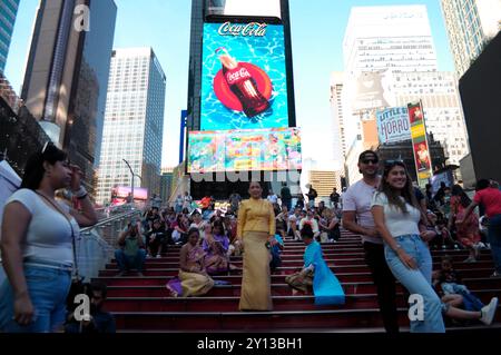 People are seen on the red stairs in Times Square, Manhattan, New York ...